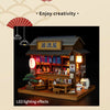 A detailed wooden miniature dollhouse kit of a Japanese restaurant with LED lighting effects.