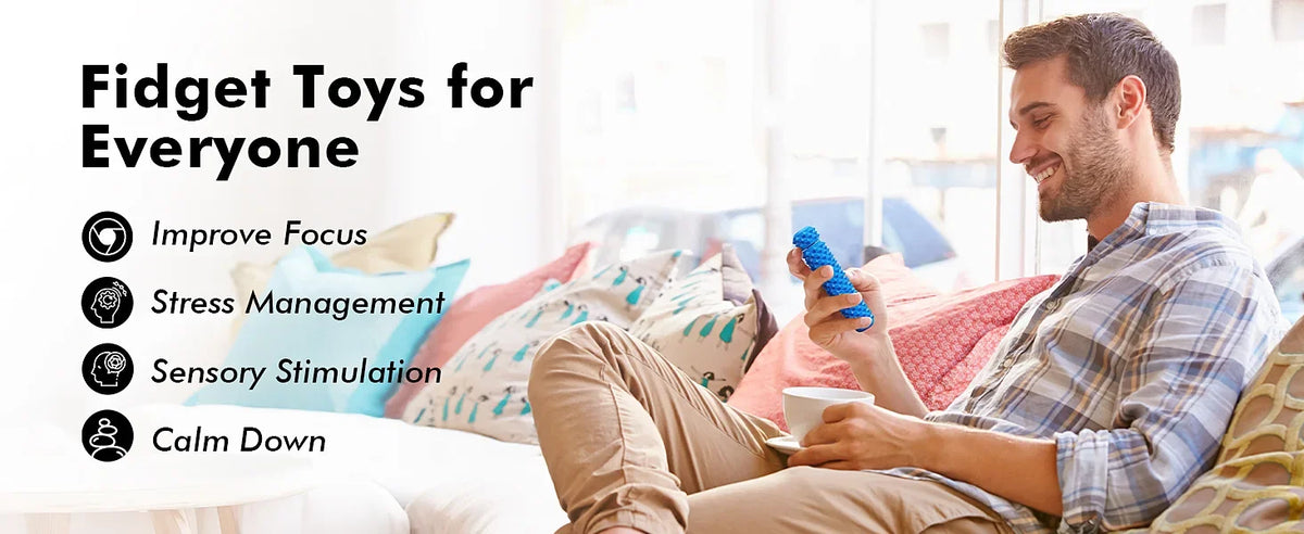 A man is relaxing and playing with a blue fidget toy while sitting on a couch.