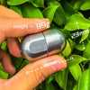 A hand holds a silver magnetic levitating fidget slider, measuring 46mm in length.