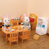 A miniature dollhouse furniture set featuring a white rabbit figure and wooden dining table and chairs.