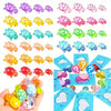 A hand holds a collection of glow in the dark mini turtle collectible figurines in various colors and shapes.