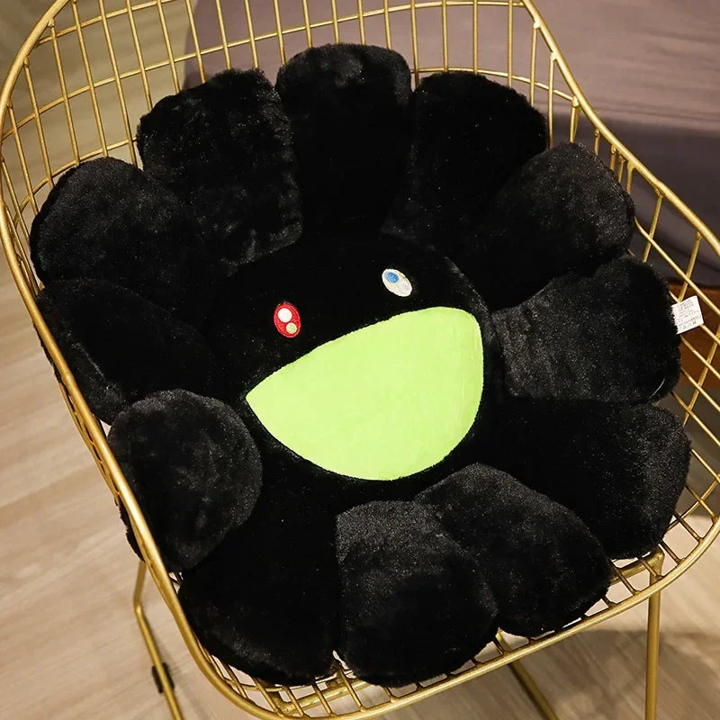 A black sunflower plush cushion with a bright lime green center and small white eyes, displayed in a gold wire basket.