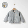 A light gray padded jacket for kids featuring a letter print on the chest, displayed on a hanger.