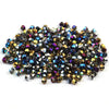A pile of small, faceted electroplated crystal glass beads in various shades of gold, bronze, and deep blue/purple.