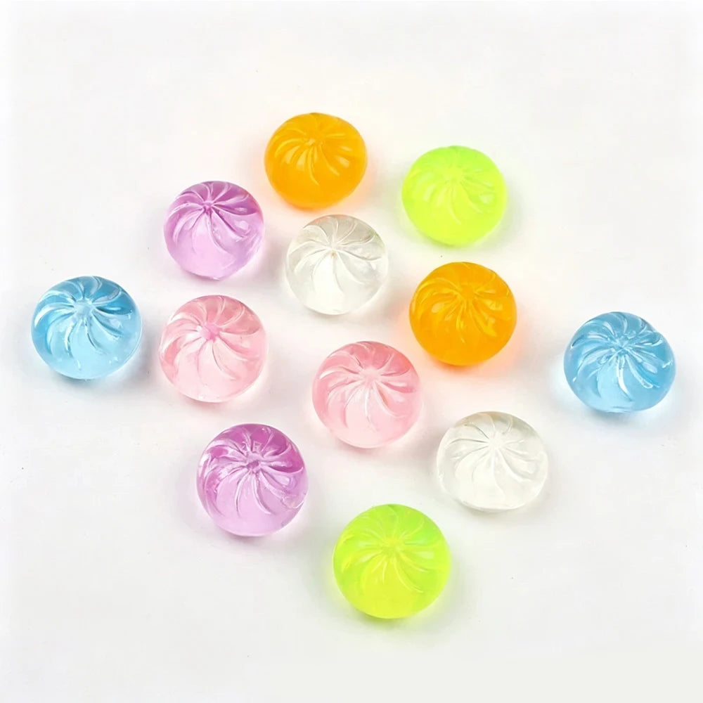 A set of five colorful, translucent squishy toys shaped like dumplings, including yellow, green, pink, and blue varieties.
