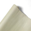 A close-up view of a beige PU leather self-adhesive repair patch.