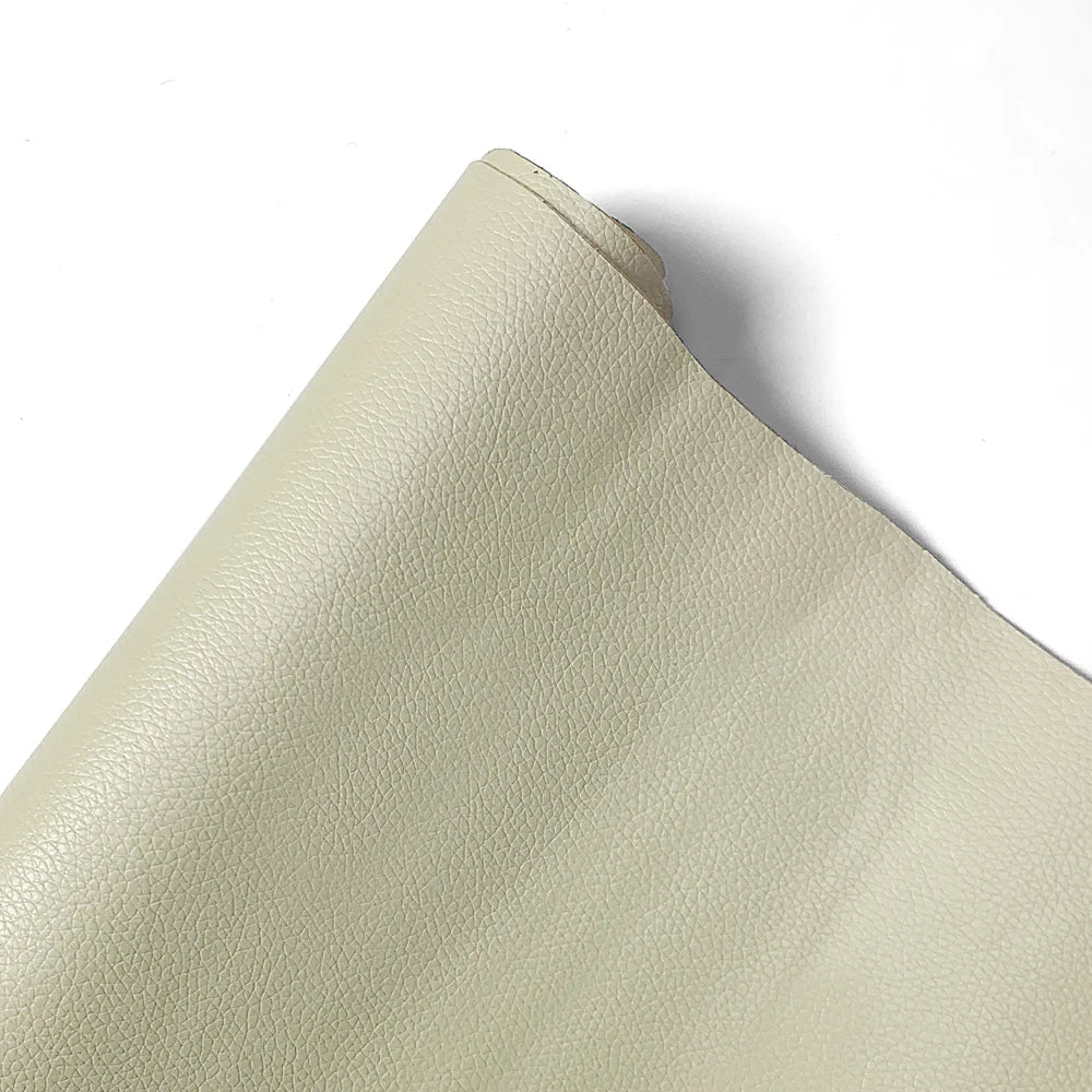 A close-up view of a beige PU leather self-adhesive repair patch.