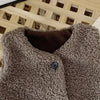 A close-up of a brown plush fleece vest for children, showing the texture and a dark button closure.