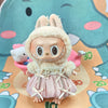 A small doll wearing a wedding dress outfit set with light pink fabric and white accents.