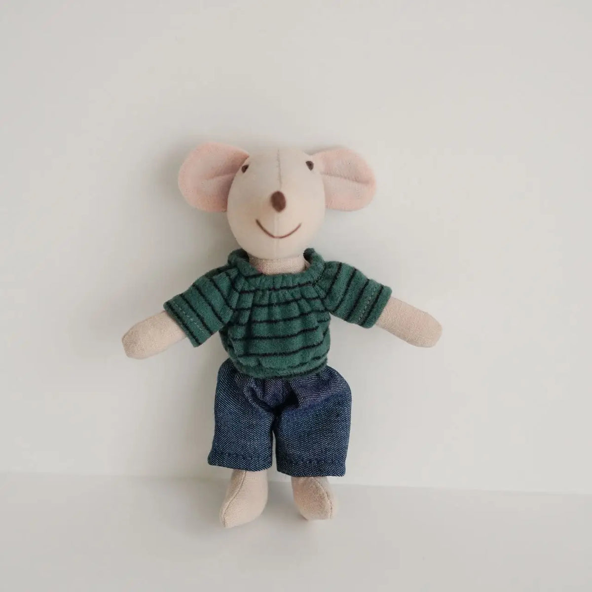A handmade mouse plush doll wearing a green striped shirt and dark blue shorts.