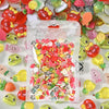 A clear plastic bag filled with a mix of colorful 3D resin nail charms in various shapes and colors.