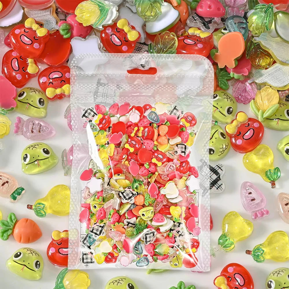 A clear plastic bag filled with a mix of colorful 3D resin nail charms in various shapes and colors.