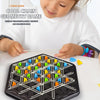 A child is playing a geometric chain game using wooden sticks and colored pieces on a black board.