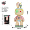 A micro building block kit shaped like a bear, featuring pink and yellow colors.