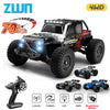A black and red off-road RC monster truck with LED lights and a remote control transmitter.