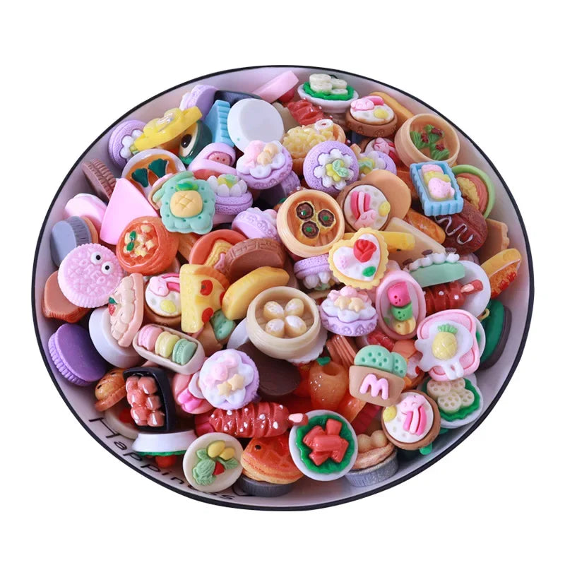 A colorful assortment of miniature dollhouse snack food items including cakes cookies and pastries