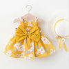 A yellow floral dress for a baby girl with a bow and a white sunhat