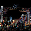 A vibrant night cityscape with illuminated buildings and fireworks against a dark sky.