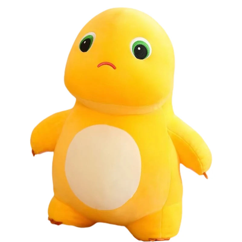 A yellow, smiling dinosaur plush toy with large green eyes and a light beige belly.