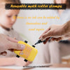 A hand is using a yellow math roller stamp to add ink for first use on paper.