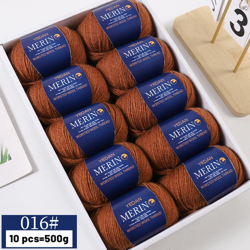 A box of YEDAN MERINO worsted wool thread yarn in brown and blue packaging.