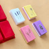 A collection of colorful silicone soap molds in various shapes and colors resting on a light brown surface.