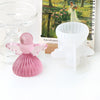 A pink silicone mold shaped like a cherub angel is displayed next to a white mold for candles or soap.