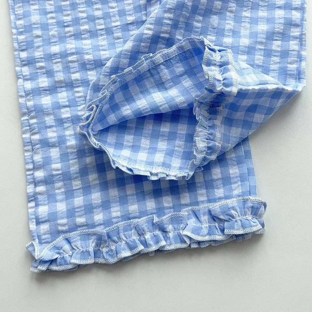 A light blue and white checkered lace vest and wide-leg pants set displayed flat.