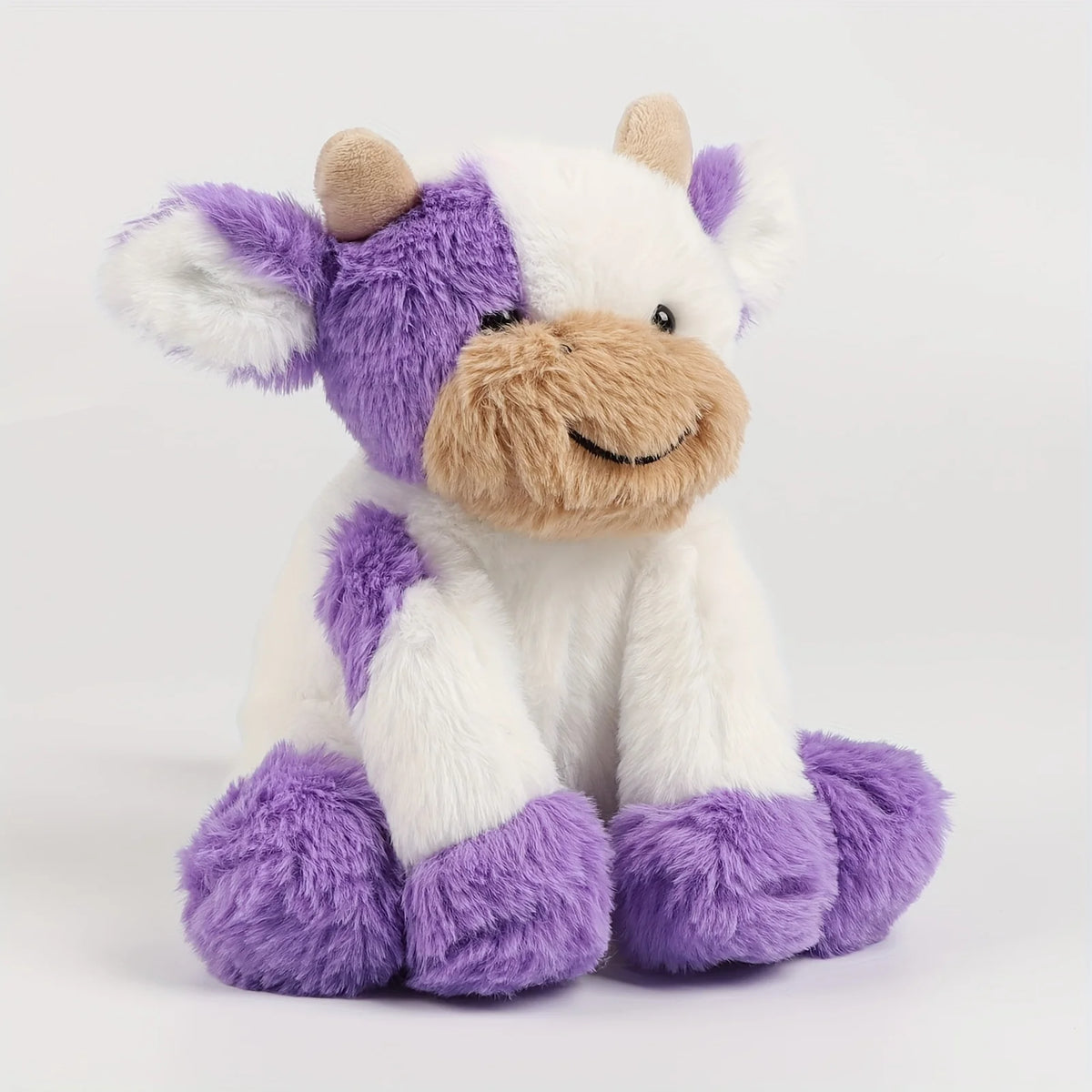 A soft cuddly cow plush toy with white and purple fur and light brown accents.