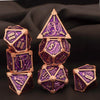 A set of seven premium metal polyhedral dice in purple and gold, displayed against a dark background.