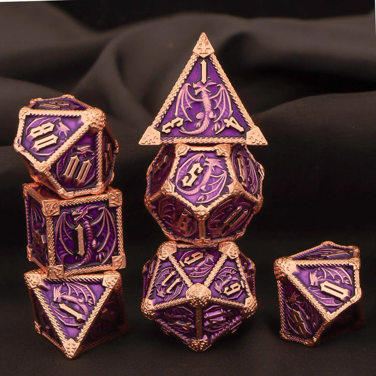 A set of seven premium metal polyhedral dice in purple and gold, displayed against a dark background.
