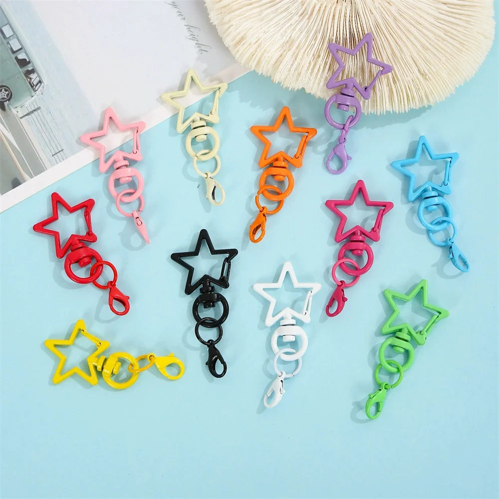 A collection of colorful lobster clasp keychains in various colors like pink, yellow, orange, purple, and green arranged on a