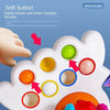 A white sensory toy with various colored buttons and rings for babies and toddlers.