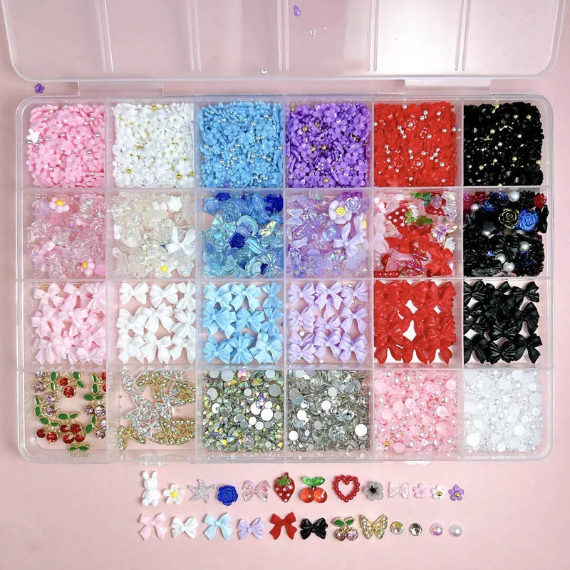 A clear plastic box filled with various DIY nail art charms including bows, flowers, fruits, and butterflies in multiple colo