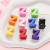 A collection of colorful acrylic letter beads shaped like the letter Z in various shades and sizes.