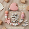Pink silicone pacifier clip with name letter beads spelling out Liam Emma Maya