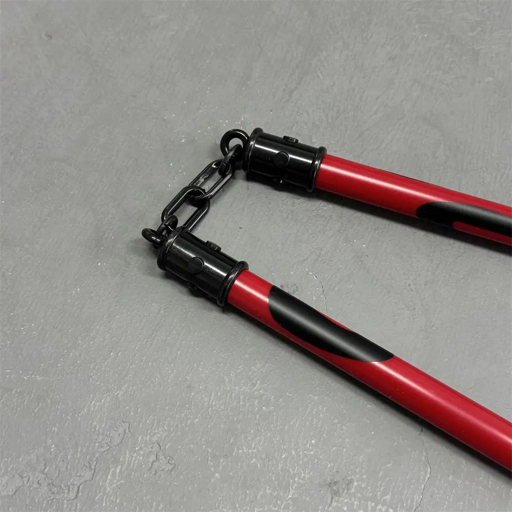 A pair of black and red cosplay props resembling a cloud or staff, featuring metal chains.