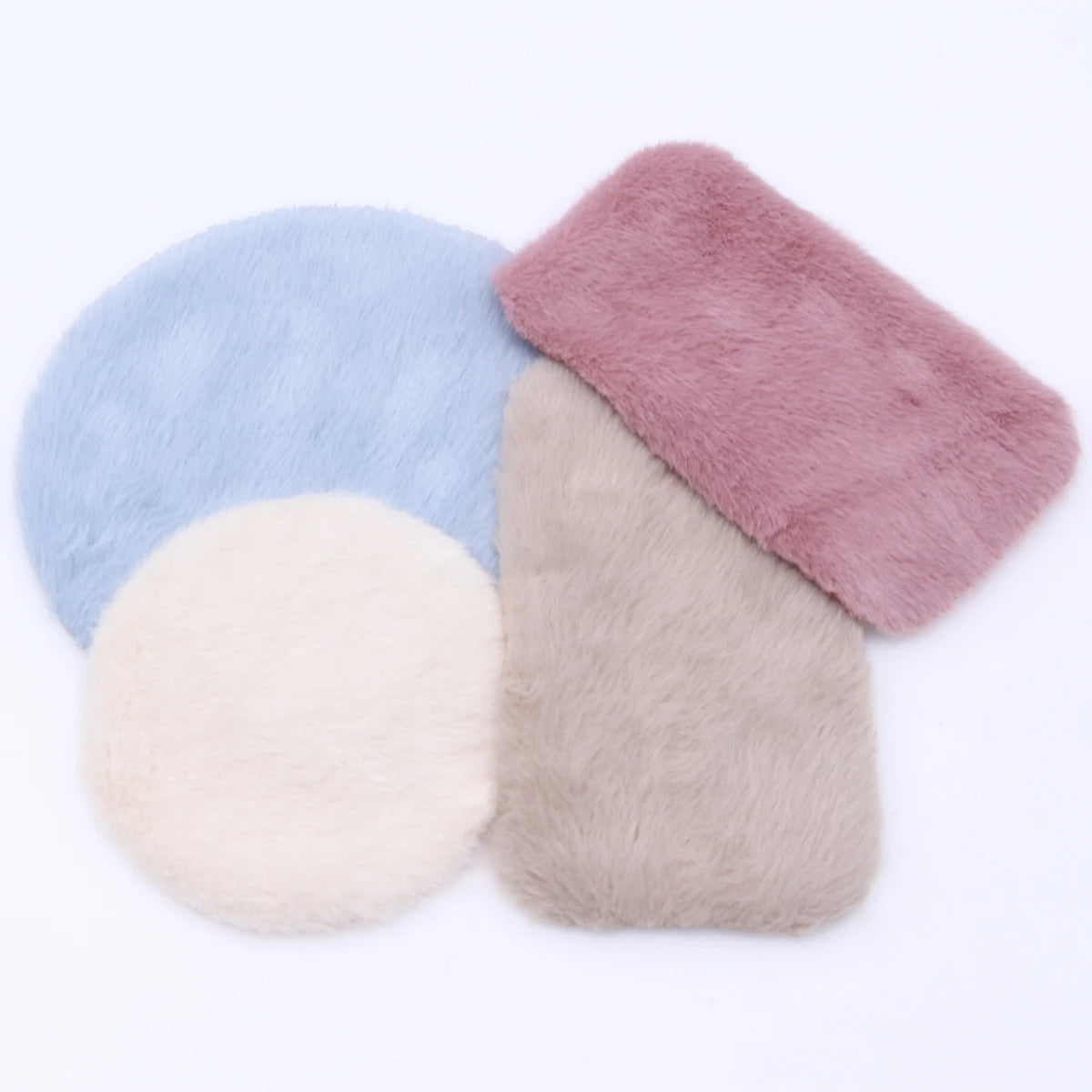 Three miniature carpet mats in shades of blue, pink, and beige for dollhouse decor