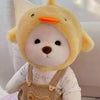 A yellow teddy bear plush wearing a light-colored shirt and overalls.