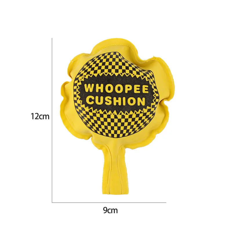 Yellow whoopee cushion with a black and yellow checkered pattern and the text WHOOPEE CUSHION