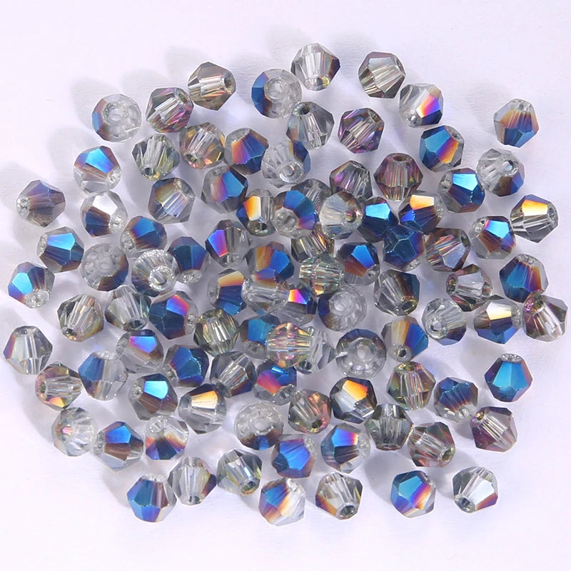 A collection of faceted crystal bicone glass beads in various shades of blue and purple.