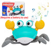 A bright blue electric crab toy with large eyes and claws is shown against a white background.