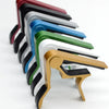 A set of aluminum alloy quick-change guitar caps in various colors arranged diagonally.