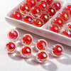 A collection of shiny red and pink acrylic craft beads arranged in a white dish.