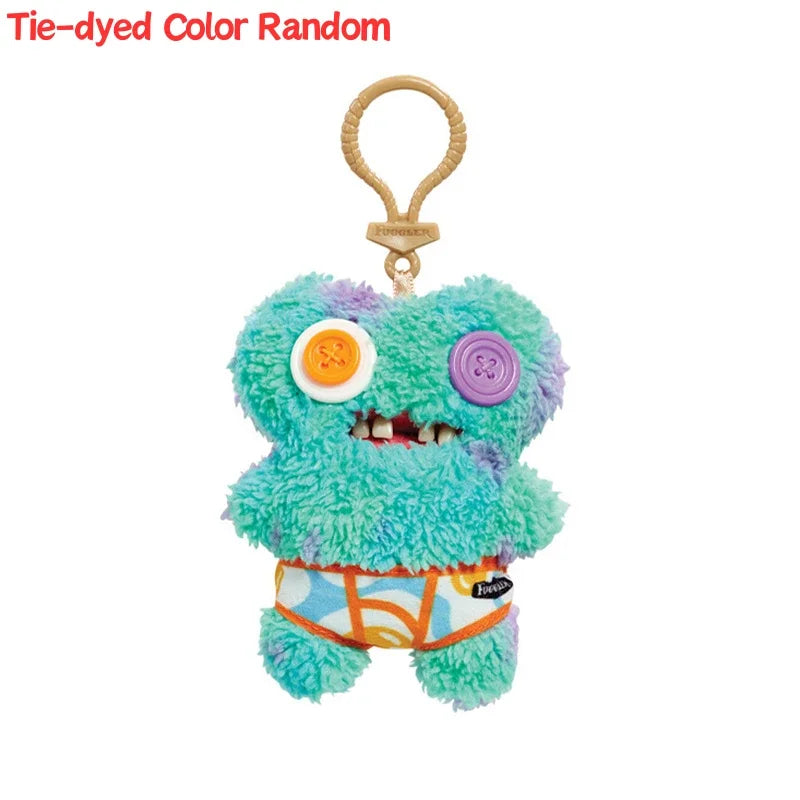 Tie-dyed color random plush monster keychain with purple and blue fur and a bright orange belly