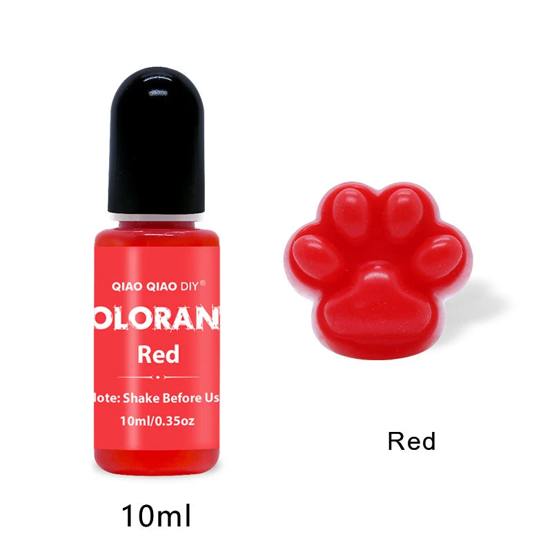 A small glass bottle of red liquid dye with a black cap next to a bright red paw print shape.