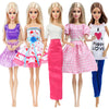 Five dolls wearing various casual outfits including purple, pink, and white dresses and pants