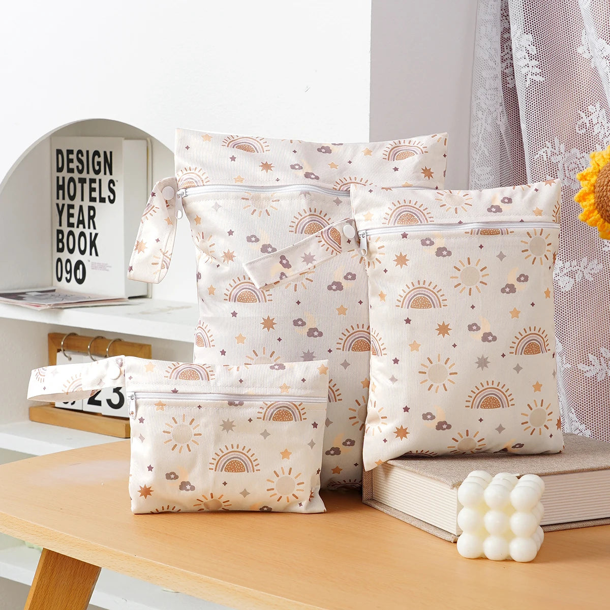 A set of three beige waterproof bags for storing swimsuits, diapers, and travel items.