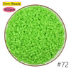 A pile of 5mm green plastic beads, 500 pieces, used for craft projects.