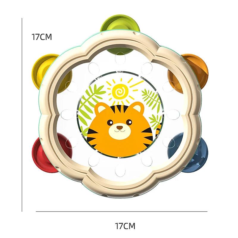 A round, light-colored musical instrument set featuring a hand drum and shake rattle for toddlers.